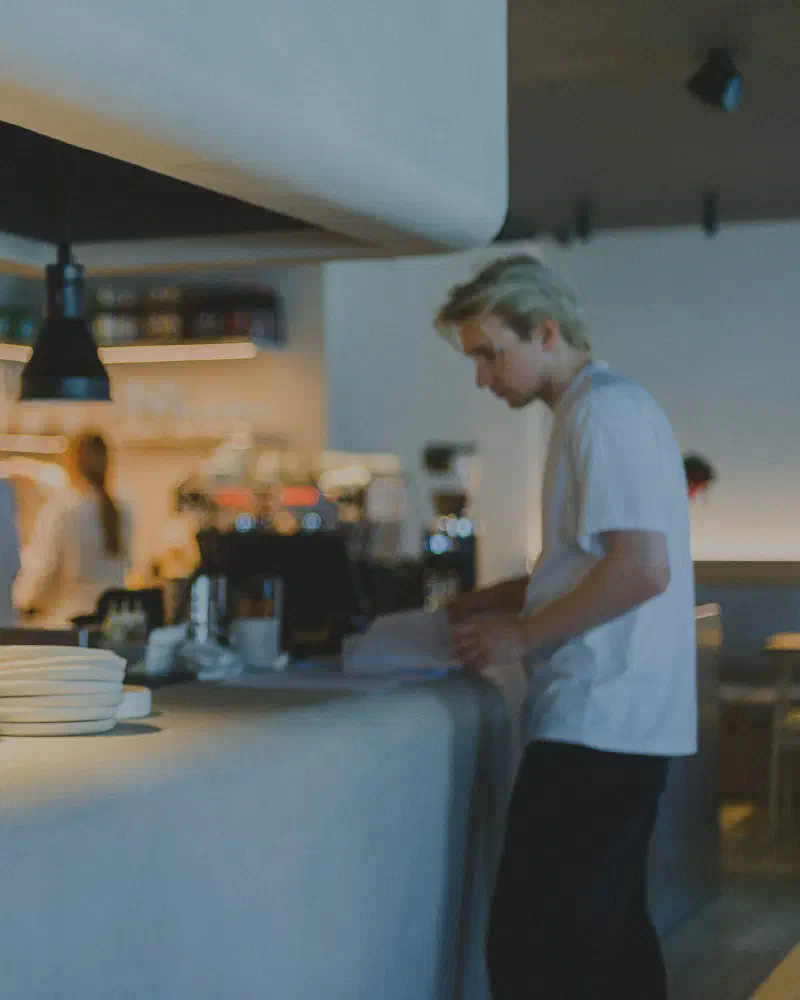 Staff preparing orders behind a café counter